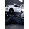 Car in a garage for maintenance, oil, tyre change (shallow DOF; color toned image)