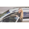 Pretty young woman by her car ready for her daily commute to work