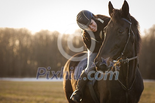 Female horse rider riding outdoors on her lovely horse Female horse rider riding outdoors on her lovely horse