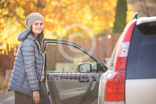 Pretty young woman by her car ready for her daily commute to work Pretty young woman by her car ready for her daily commute to work