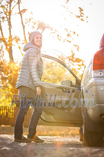 Pretty young woman by her car ready for her daily commute to work Pretty young woman by her car ready for her daily commute to work