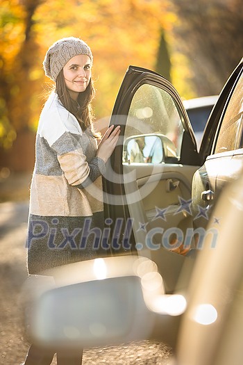 Pretty young woman by her car ready for her daily commute to work Pretty young woman by her car ready for her daily commute to work