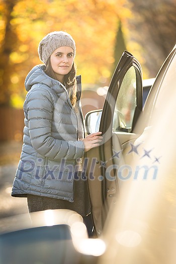 Pretty young woman by her car ready for her daily commute to work Pretty young woman by her car ready for her daily commute to work