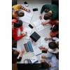 Top view of university students sitting at a table studying and working on laptop