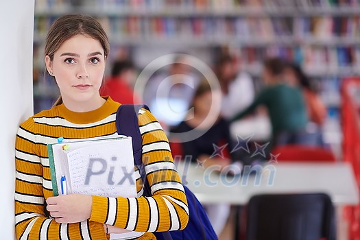 a portrait of a girl holding a notebook in her hand while standing in front of the library a portrait of a girl holding a notebook in her hand while standing in front of the library