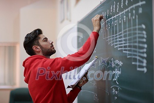the student uses a book trying to make a math problem on the board the student uses a book trying to make a math problem on the board