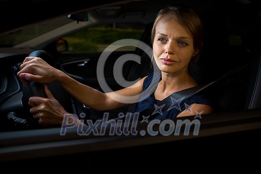 Driving a car at night - pretty, young woman driving her modern car at night, in a city (shallow DOF; color toned image) Driving a car at night - pretty, young woman driving her modern car at night, in a city (shallow DOF; color toned image)
