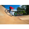 Bmx rider jumping over on a U ramp in a skatepark (motion blurred image)