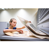 Pretty, young woman studying old maps in archives