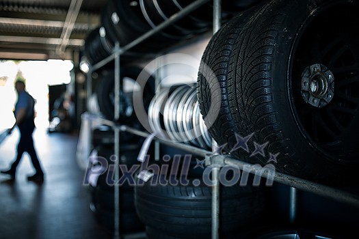 Tyre change - wheel balancing or repair and change car tire at auto service garage or workshop by mechanic Tyre change - wheel balancing or repair and change car tire at auto service garage or workshop by mechanic