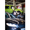Tyre change - wheel balancing or repair and change car tire at auto service garage or workshop by mechanic