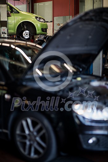 Tyre change - wheel balancing or repair and change car tire at auto service garage or workshop by mechanic Tyre change - wheel balancing or repair and change car tire at auto service garage or workshop by mechanic