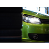 Car in a garage for maintenance, oil, tyre change (shallow DOF; color toned image)