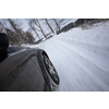 Fast moving car on a winter alpine snowy road