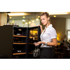 Cute female sommelier/wine waiter choosing the right wine to go well with food in a restaurant