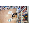 student taking notes from a book at library. Young woman sittingin in school library and working with laptop