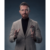 Portrait of a successful stylish elegant senior businessman with a grey beard and casual business clothes confident in photo studio isolated on dark background gesturing with hands. High-quality photo