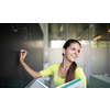 Female university student in front of a blackboard solving a problem - Young teacher in classroom drawing a planimetry problem on the blackboard