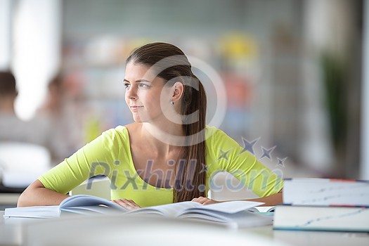 Cute female university/highschool student with books in library Cute female university/highschool student with books in library