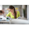 Cute female university/highschool student with books in library