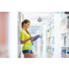 Cute female university/highschool student with books in library