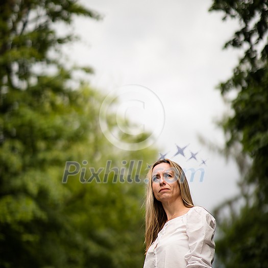 Portrait of a relaxed middle aged woman outdoors, looking happy, enjoying the life Portrait of a relaxed middle aged woman outdoors, looking happy, enjoying the life