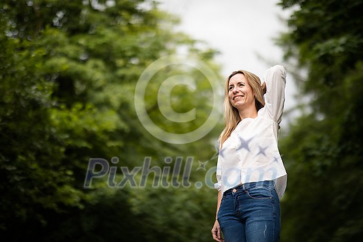 Portrait of a relaxed middle aged woman outdoors, looking happy, enjoying the life Portrait of a relaxed middle aged woman outdoors, looking happy, enjoying the life