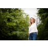 Portrait of a relaxed middle aged woman outdoors, looking happy, enjoying the life