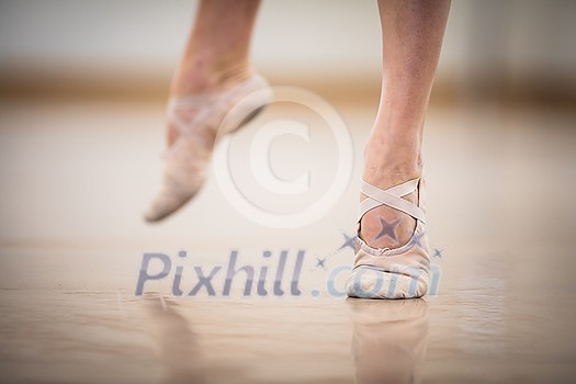 Legs and slippers of classical ballet dancers rehearsing Legs and slippers of classical ballet dancers rehearsing