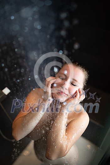 Pretty,young woman taking a long hot shower in a modern bathroom Pretty,young woman taking a long hot shower in a modern bathroom