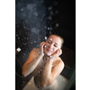 Pretty,young woman taking a long hot shower in a modern bathroom