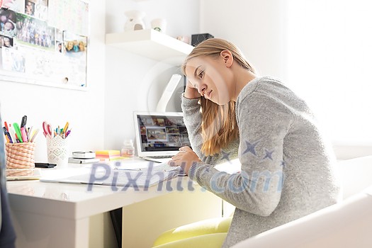 Teenage girl homeschooled due to COVID pandemics, following online classes Teenage girl homeschooled due to COVID pandemics, following online classes