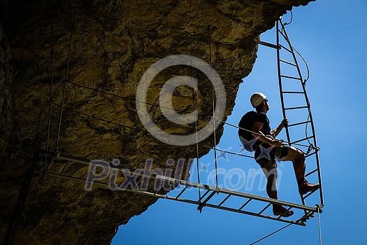 Young people on a via ferrata route in Swiss Alps Young people on a via ferrata route in Swiss Alps