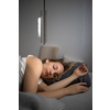 Pretty, young woman sleeping in her bed late in the morning on a weekend - compensating for the lack of sleep