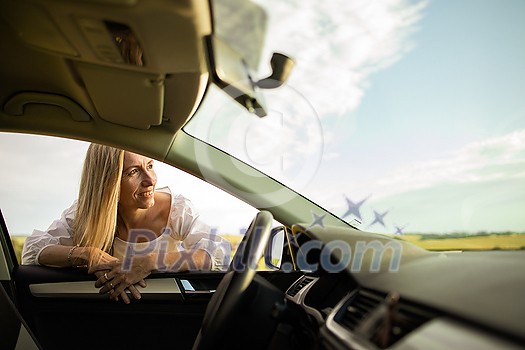 Pretty middle aged woman at the steering wheel of her car Pretty middle aged woman at the steering wheel of her car