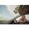 Pretty middle aged woman at the steering wheel of her car