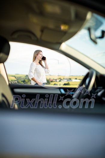 Pretty midle aged woman at the steering wheel of her car, having a break on a long trip, making a phone call Pretty midle aged woman at the steering wheel of her car, having a break on a long trip, making a phone call
