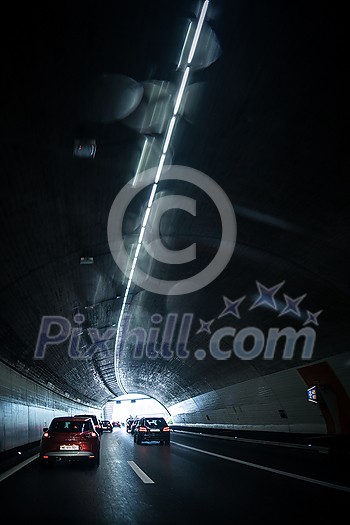 Cars on a highway going through a long modern tunnel (motion blurred image; color toned image) Cars on a highway going through a long modern tunnel (motion blurred image; color toned image)