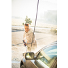 Pretty, young woman washing her car in a manual carwash (color toned image)