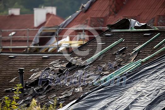 Storm damaged roof, destroyed roof tiles, expensive damage needing prompt repair Storm damaged roof, destroyed roof tiles, expensive damage needing prompt repair