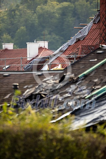 Storm damaged roof, destroyed roof tiles, expensive damage needing prompt repair Storm damaged roof, destroyed roof tiles, expensive damage needing prompt repair