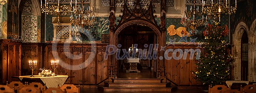 Splendid chandelier with lit candles in a beautiful room of an old mansion Splendid chandelier with lit candles in a beautiful room of an old mansion
