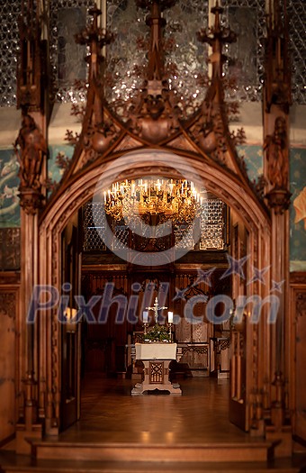 Splendid chandelier with lit candles in a beautiful room of an old mansion Splendid chandelier with lit candles in a beautiful room of an old mansion