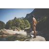 Turquoise waters of Verzasca river near Lavertezzo, Ticino, Switzerland - young man going for a swim