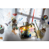 Palette and paint brush in artist hands. Artist paints oil picture with paint brush in hand palette close-up. Artist painting holding palette and paint brush in hand. Artists paintbrush with palette.