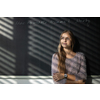 Pretty, young female student in front of a blackboard during class