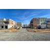 Modern and new apartment building. Multistoried modern, new and stylish living block of flats. Selective DOF, focus on the grass with blurred buildings in the background (ample copy space)