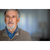 Portrait of happy senior man smiling at home. Close up face of elderly guy enjoying retirement.