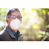 Senior man with glasses fogged due to condensation caused by the use of a face mask, respirator