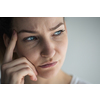 Anxious, worried, stressed young woman looking pensive, pondering, deep in thoughts.
